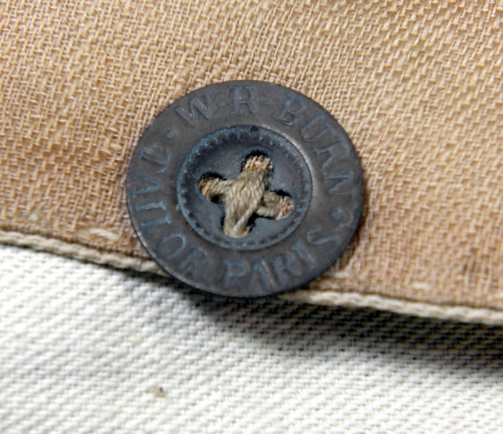 A European manufactured button marked W. R. Burn Tailor Paris