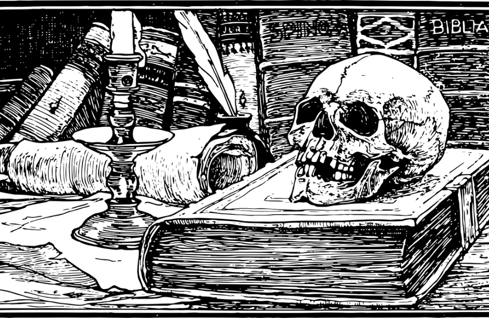 Skull and book on table with quill
