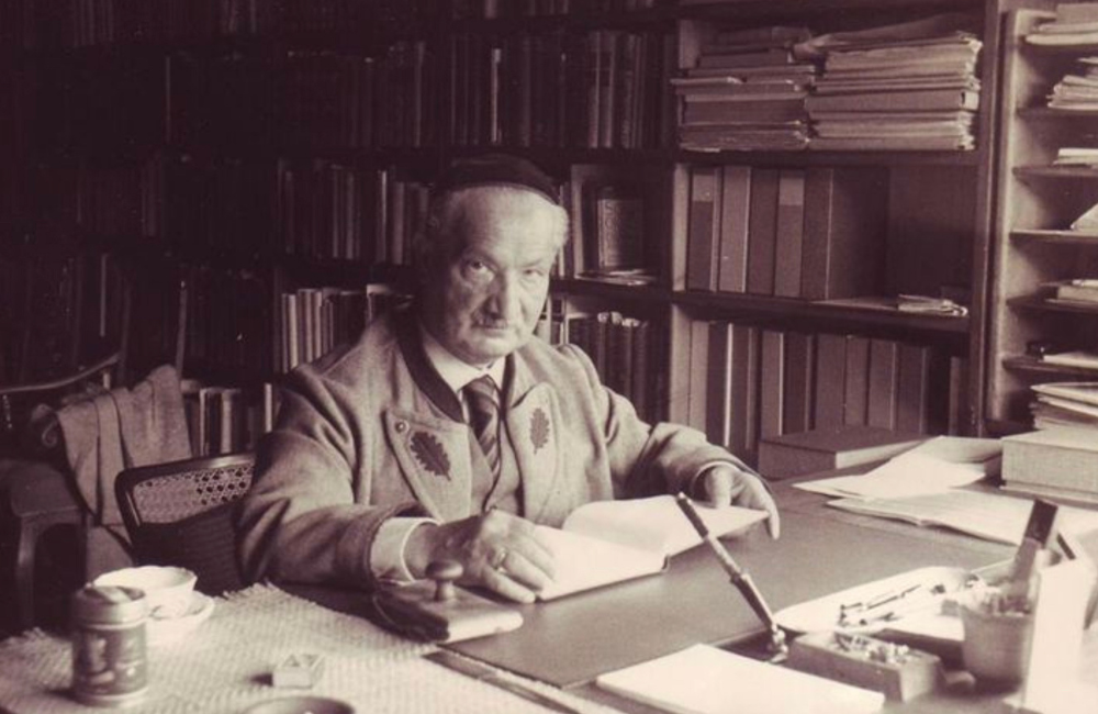 Heidegger working at his desk