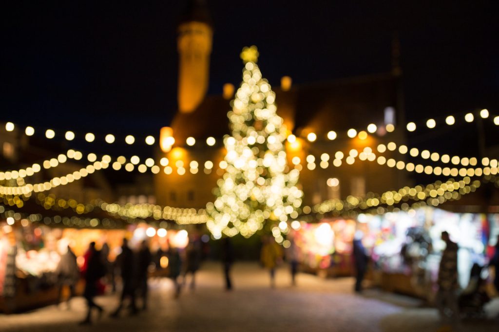 A Christmas Market at night with Christmas Tree and lights, blurred